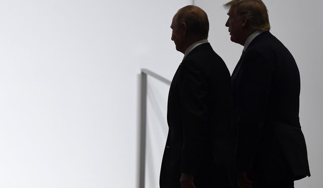 In this June 28, 2019, photo, President Donald Trump and Russian President Vladimir Putin walk to participate in a group photo at the G20 summit in Osaka, Japan. An odd new front in the U.S.-Russian rivalry has emerged as a Russian military cargo plane bearing a load of urgently needed medical supplies landed in New York’s JFK airport. (AP Photo/Susan Walsh, File)