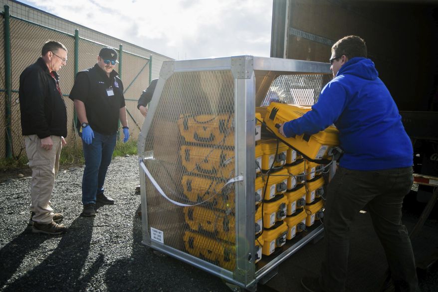 Tony Miller, Yakima County emergency management director; Horace Ward, operations manager of Yakima Valley Office of Emergency Management; and Blake Scully, a resource supply officer, fromleft, evaluate how many ventilators arrived from the weekly supply shipment Thursday, April 2, 2020, at the Yakima County Office of Emergency Management in Union Gap, Wash. (Amanda Ray/Yakima Herald-Republic via AP)