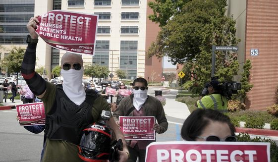 Nurses at UCI Medical Center protest the lack of personal protective equipment available in light of the COVID-19 outbreak in Orange, Calif., Friday, April 3, 2020. (AP Photo/Chris Carlson) ** FILE **