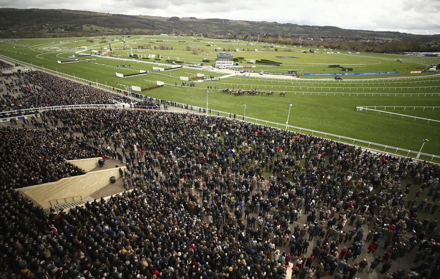 FILE - In this Wednesday March 11, 2020 file photo, a general view from the Grand Stand of the Ballymore Novices' Hurdle the Cheltenham Horse Racing Festival at Cheltenham Racecourse, England. Cheltenham Festival organisers have defended their decision to go ahead with the meeting last month after fears were raised that the mass gathering of people for the annual horse racing event helped spread coronavirus more widely around Britain. (Tim Goode/PA via AP, File)