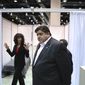 Illinois Gov. J.B. Pritzker tours Hall C Unit 1 of the COVID-19 alternate site at McCormick Place in Chicago on Friday, April 3, 2020. Hall C is planned to have 500 beds. In the background is Christina Bratis, clinical chief of staff of the facility. (Chris Sweda/Chicago Tribune via AP, Pool)