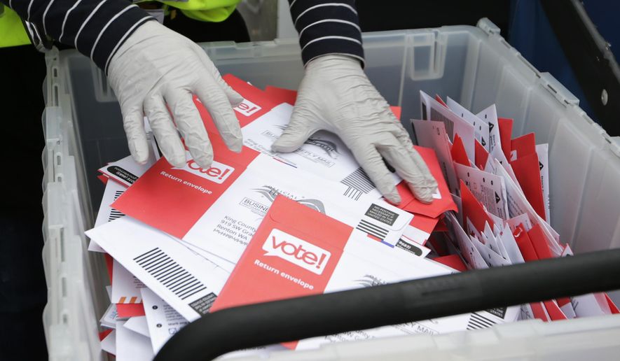 FILE - In this March 10, 2020, file photo wearing gloves, a King County Election worker collect ballots from a drop box in the Washington State primary, in Seattle. But the 2020 presidential election is creeping ever closer, and there are no signs yet of pandemic abating, nor any word on when Americans on orders to stay home can resume normal life, and so lawmakers are trying to figure how to allow for voting in a world where face-to-face contact causes anxiety at the least, and sickness and death at the most. (AP Photo/John Froschauer, File)