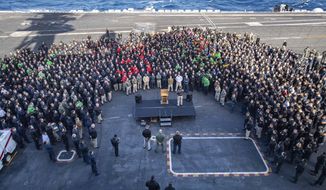 In this Dec. 15, 2019, photo U.S.Navy Capt. Brett Crozier, commanding officer of the aircraft carrier USS Theodore Roosevelt (CVN 71), addresses the crew during an all hands call on the ship&#39;s flight deck while conducting routine training in the Eastern Pacific Ocean. U.S. defense leaders are backing the Navy&#39;s decision to fire the ship captain who sought help for his coronavirus-stricken aircraft carrier, even as videos showed his sailors cheering him as he walked off the vessel. Videos went viral on social media Friday, April 3, 2020, showing hundreds of sailors gathered on the ship chanting and applauding Navy Capt. Brett Crozier as he walked down the ramp, turned, saluted, waved and got into a waiting car. (U.S. Navy Photo by Mass Communication Specialist Seaman Kaylianna Genier via AP)