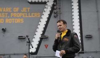 In this Nov. 15, 2019, photo U.S. Navy Capt. Brett Crozier, commanding officer of the aircraft carrier USS Theodore Roosevelt (CVN 71), addresses the crew during an all-hands call on the ship&#39;s flight deck. (U.S. Navy Photo by Mass Communication Specialist 3rd Class Nicholas Huynh via AP)