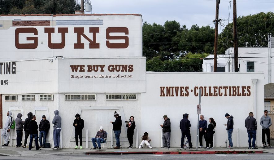 In this March 15, 2020, file photo, people wait in line to enter a gun store in Culver City, Calif. A federal judge is refusing to block Los Angeles officials from shutting down gun stores as nonessential businesses during the coronavirus pandemic. On Monday, April 6, 2020, the ruling the second time was that federal judges in California have declined to intervene in shutdown orders even as similar orders are being challenged nationwide. (AP Photo/Ringo H.W. Chiu, File)