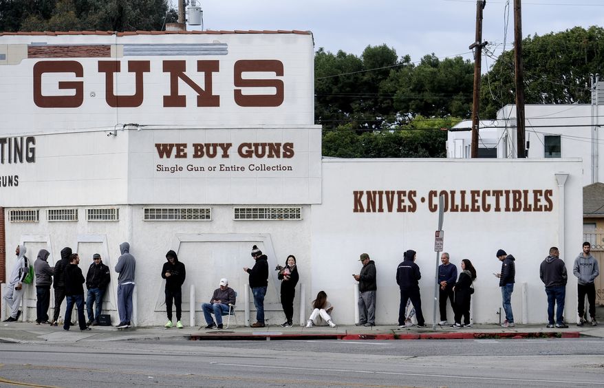 In this March 15, 2020, file photo, people wait in line to enter a gun store in Culver City, Calif. A federal judge is refusing to block Los Angeles officials from shutting down gun stores as nonessential businesses during the coronavirus pandemic. On Monday, April 6, 2020, the ruling the second time was that federal judges in California have declined to intervene in shutdown orders even as similar orders are being challenged nationwide. (AP Photo/Ringo H.W. Chiu, File)