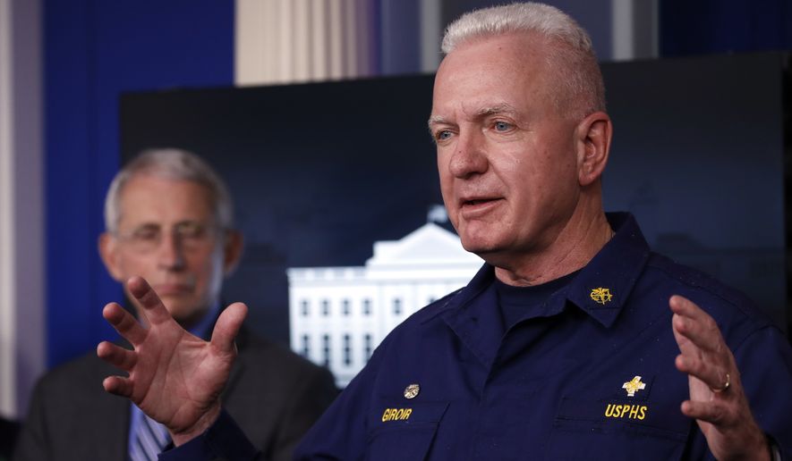 Adm. Brett Giroir, assistant secretary of Health and Human Services, speaks about the coronavirus in the James Brady Press Briefing Room of the White House, Monday, April 6, 2020, in Washington, as Dr. Anthony Fauci, director of the National Institute of Allergy and Infectious Diseases, listens. (AP Photo/Alex Brandon)