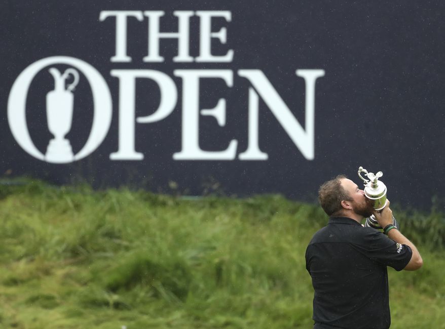 FILE - In this Sunday, July 21, 2019 file photo Ireland&#x27;s Shane Lowry holds and kisses the Claret Jug trophy on the 18th green as he poses for the crowd and media after winning the British Open Golf Championships at Royal Portrush in Northern Ireland. The organizers of the British Open announced Monday April 6, 2020, that they have decided to cancel the event in 2020 due to the current Covid-19 pandemic and that the Championship will next be played at Royal St George&#x27;s in 2021. (AP Photo/Peter Morrison)