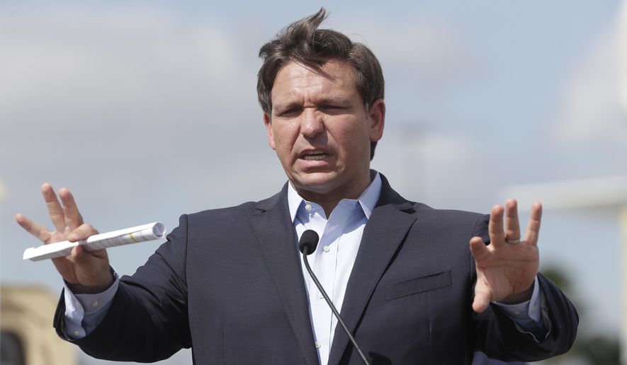In this March 30, 2020, file photo Florida Gov. Ron DeSantis speaks during a news conference at a drive-through coronavirus testing site in front of Hard Rock Stadium in Miami Gardens, Fla. (AP Photo/Wilfredo Lee, File)