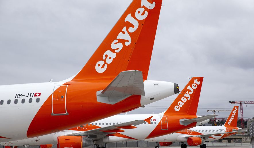 A large number of easyJet aircrafts are parked on the tarmac of the Geneve Aeroport, in Geneva, Switzerland, Monday, March 30, 2020. EasyJet, a British low-cost airline, on 30 March 2020 said it is ground its entire fleet of more than 300 planes amid ongoing Coronavirus COVID-19 crisis. The new coronavirus causes mild or moderate symptoms for most people, but for some, especially older adults and people with existing health problems, it can cause more severe illness or death. (Salvatore Di Nolfi/Keystone via AP)