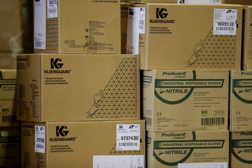 Boxes of medical personal protective equipment are seen at the Texas Department of Public Safety warehouse facility in Austin, Texas, as Texas Gov. Greg Abbott gives an update on the COVID-19 outbreak Monday, April 6, 2020. The new coronavirus causes mild or moderate symptoms for most people, but for some, especially older adults and people with existing health problems, it can cause more severe illness or death. (AP Photo/Eric Gay)