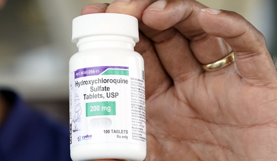 Dr. Robin Armstrong holds a bottle of hydroxychloroquine while posing outside The Resort at Texas City nursing home, where he is the medical director, Tuesday, April 7, 2020, in Texas City, Texas. (AP Photo/David J. Phillip) ** FILE **