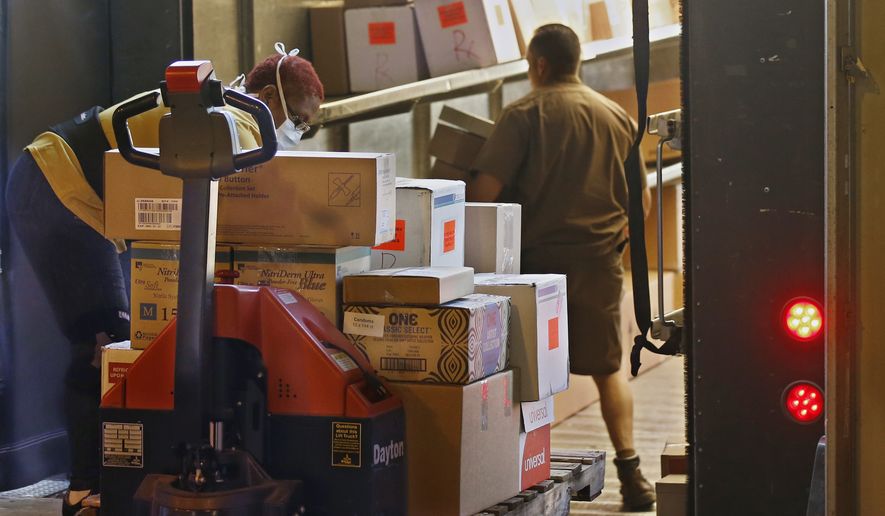 Supplies are loaded onto a delivery truck at Oklahoma's Strategic National Stockpile warehouse in Oklahoma City, Tuesday, April 7, 2020, in Oklahoma City. The warehouse is supplying first responders and health care workers across the state in the wake of the COVID-19 outbreak.The new coronavirus causes mild or moderate symptoms for most people, but for some, especially older adults and people with existing health problems, it can cause more severe illness or death. (AP Photo/Sue Ogrocki)