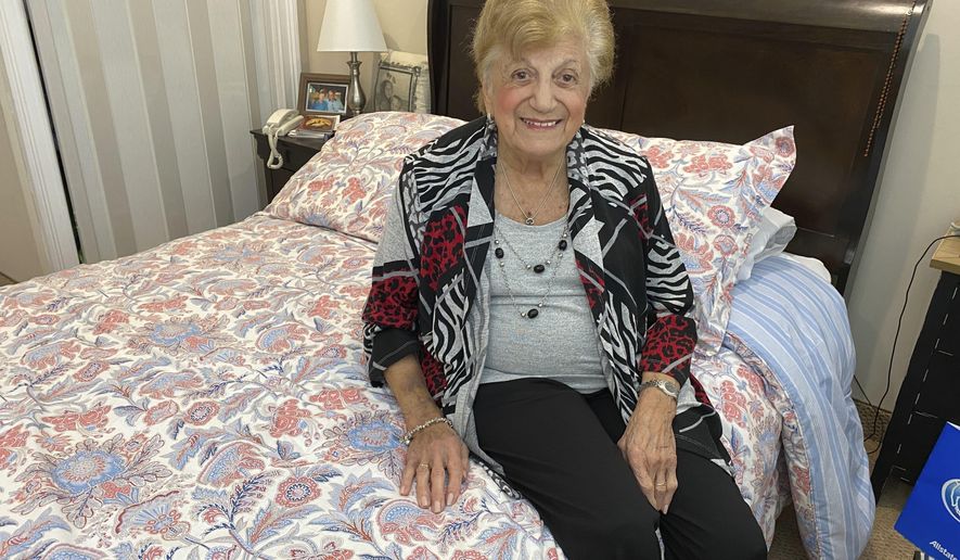 COVID-19 survivor Anna Fortunato poses for a portrait in her room at The Arbors assisted living community in Jericho, N.Y. on Tuesday, March 31, 2020. Fortunato, 90, says people should keep fighting the new coronavirus and that, "If I did it, you can do it." For most people, the virus causes mild or moderate symptoms, such as fever and cough that clear up in two to three weeks. For some, especially older adults and people with existing health problems, it can cause more severe illness, including pneumonia and death. (AP Photo/Gabriella Bruzzese)