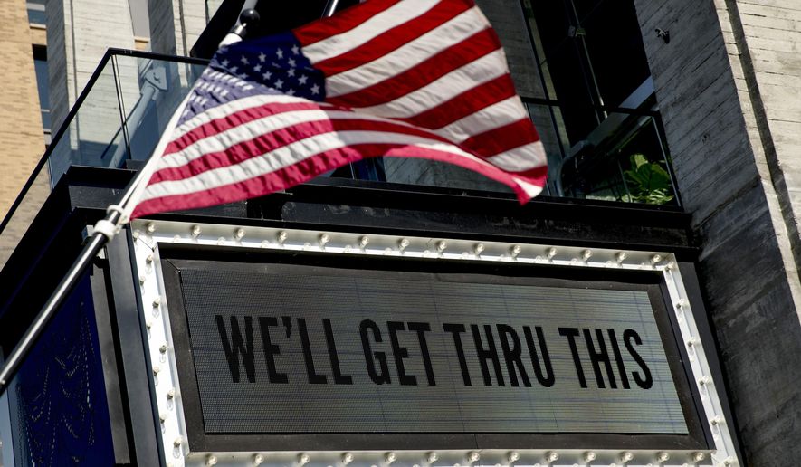 In this April 6, 2020 photo, a sign at The Anthem music venue reads "We'll Get Thru This" at the wharf which is almost completely empty because of the coronavirus outbreak in Washington. The coronavirus pandemic has gut-punched global markets, put 6.6 million Americans out of work and raised the strong likelihood of a recession. But in the Washington lobbying world, business is booming. (AP Photo/Andrew Harnik)