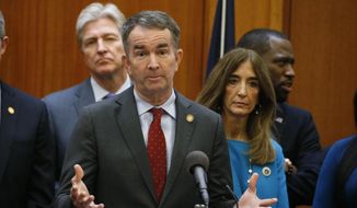 This March 12, 2020 file photo shows Virginia Gov. Ralph Northam, front, gesturing during a news conference as House speaker Eileen Filler-Corn, right, and Secretary of Public safety Brian Moran, left, look on at the Capitol in Richmond, Va. Northam plans to delay some long-sought Democratic priorities until more is known about how the pandemic will affect the economy, pushing back decisions on whether to give teachers and state workers raises, freeze in-state college tuition, and implement other new spending in the budget lawmakers passed only last month. Clark Mercer, the governor&#39;s chief of staff, said Tuesday, April 7, 2020 that too little is known about the impact on state revenues to move ahead now with billions of dollars in new spending, much of which would carry over into future years. (AP Photo/Steve Helber)