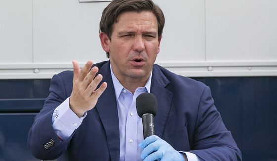 Florida Governor Ron DeSantis speaks at the Miami Beach Convention Center to discuss the U.S. Army Corps&#39; building of a coronavirus field hospital inside the facility on Wednesday, April 8, 2020. (Al Diaz/Miami Herald via AP)