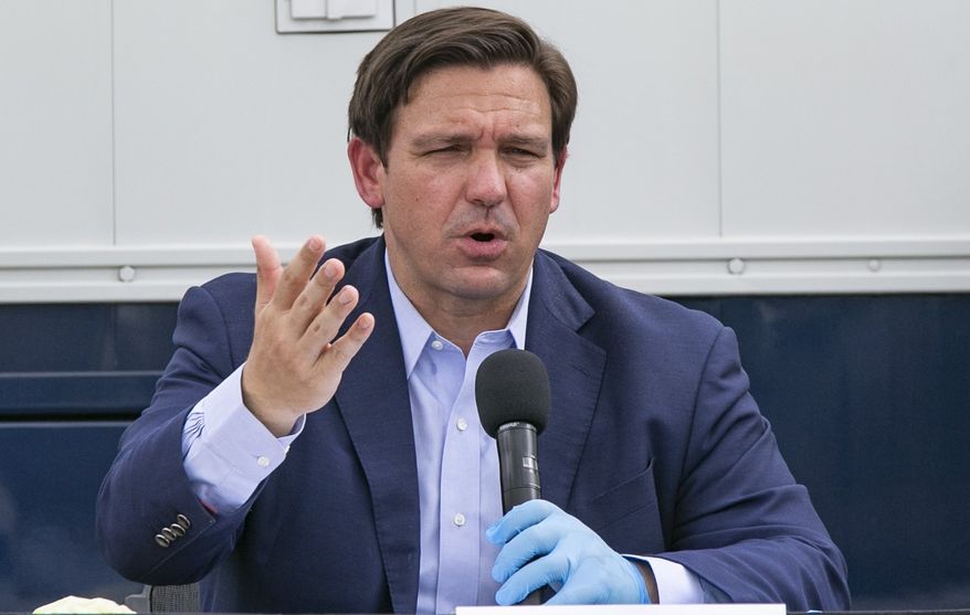 Florida Governor Ron DeSantis speaks at the Miami Beach Convention Center to discuss the U.S. Army Corps&#x27; building of a coronavirus field hospital inside the facility on Wednesday, April 8, 2020. (Al Diaz/Miami Herald via AP)