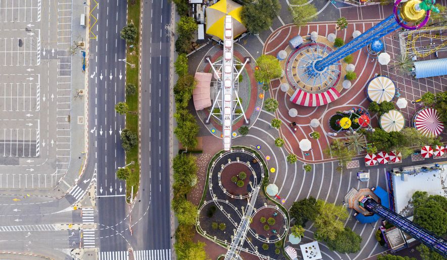 A aerial view shows a closed amusement park and empty road due to the government's measures to help stop the spread of the coronavirus, in Tel Aviv, Israel, Saturday, April 4, 2020. (AP Photo/Oded Balilty)