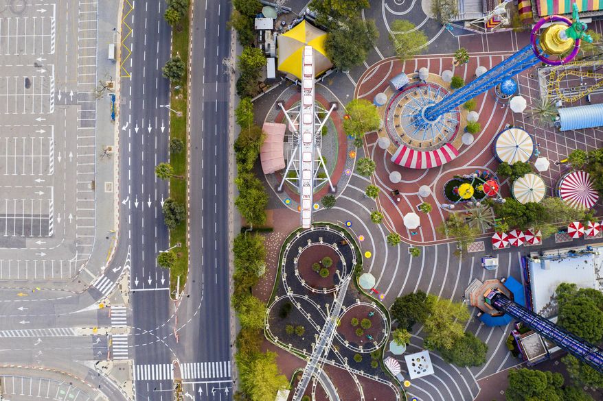 A aerial view shows a closed amusement park and empty road due to the government's measures to help stop the spread of the coronavirus, in Tel Aviv, Israel, Saturday, April 4, 2020. (AP Photo/Oded Balilty)
