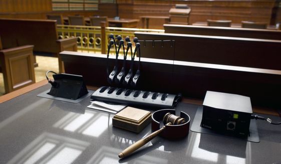 This Jan. 14, 2013, file photo shows a gavel sitting on a desk inside a courtroom.  (AP Photo/Brennan Linsley, File) **FILE**