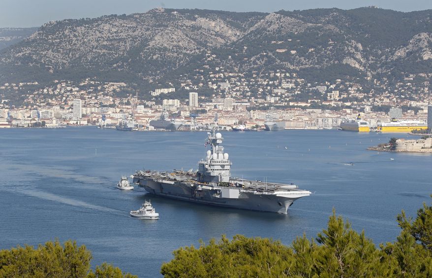 FILE - In this Nov.18, 2015 file photo, France's nuclear-powered aircraft carrier Charles de Gaulle leaves its home port of Toulon, southern France. France's defense ministry announced that French aircraft carrier Charles de Gaulle is heading back to port amid possible virus outbreak onboard. The ministry said in a statement Wednesday that around 40 troops are presenting symptoms compatible with the COVID-19 disease. The new coronavirus causes mild or moderate symptoms for most people, but for some, especially older adults and people with existing health problems, it can cause more severe illness or death. (AP Photo/Lionel Cironneau, File)