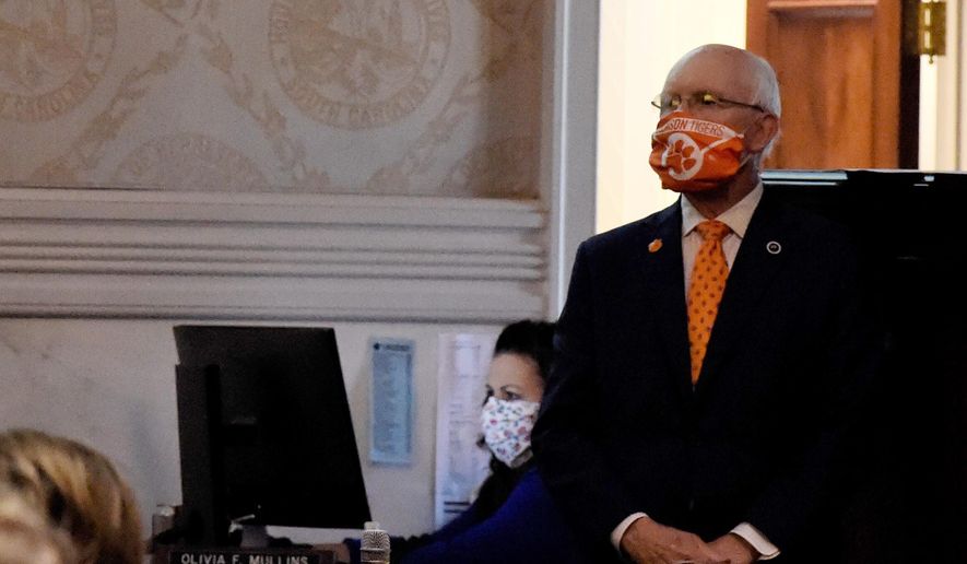 State Rep. Gary Clary wears a face mask he made from a Clemson University banner during a special, one-day session of the South Carolina Legislature on Wednesday, April 8, 2020, in Columbia, S.C. This year's session has been paused for several weeks amid the new coronavirus outbreak. (AP Photo/Meg Kinnard)