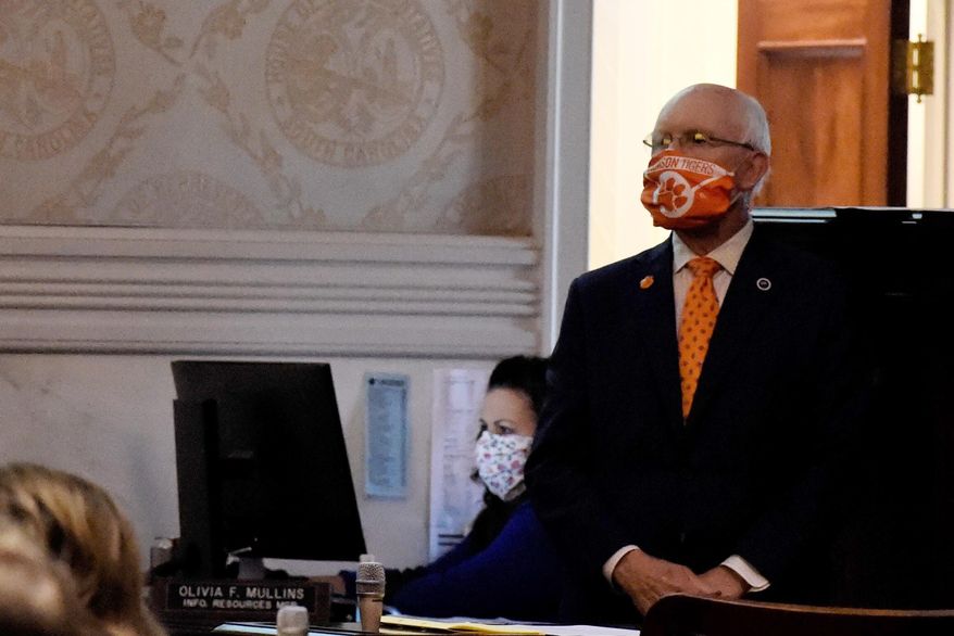 State Rep. Gary Clary wears a face mask he made from a Clemson University banner during a special, one-day session of the South Carolina Legislature on Wednesday, April 8, 2020, in Columbia, S.C. This year's session has been paused for several weeks amid the new coronavirus outbreak. (AP Photo/Meg Kinnard)