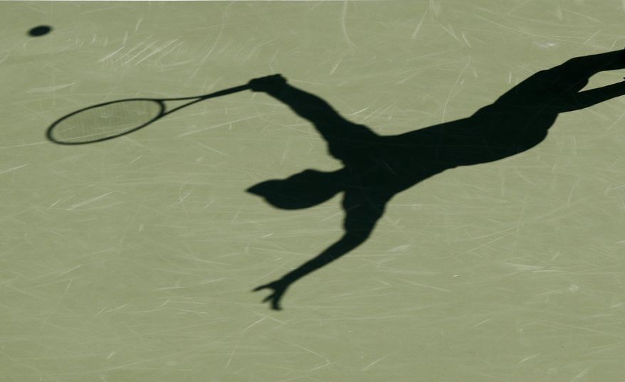 FILE - This is a 2017 file photo showing the shadow of a tennis player. The group charged with monitoring tennis gambling and punishing corruption found a near-doubling in the number of suspect matches in the first three months of 2020 -- an increase it tied to the coronavirus pandemic. (AP Photo/File)
