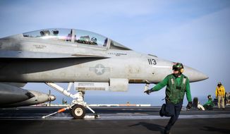ARABIAN GULF (Feb. 12, 2018) An F/A-18F Super Hornet assigned to the Fighting Redcocks of Strike Fighter Attack Squadron (VFA) 22 readies for launch on the flight deck of the aircraft carrier USS Theodore Roosevelt (CVN 71).  (U.S. Navy photo)