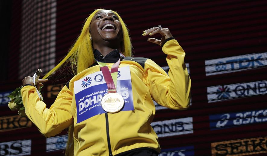FILE - In this file photo dated Monday, Sept. 30, 2019, Shelly-Ann Fraser-Pryce of Jamaica, gold medalist in the women's 100 meters, reacts during the medal ceremony at the World Athletics Championships in Doha, Qatar. Moving from their sports field to the living room, many athletes around the world are doing their bit to boost public health during the coronavirus pandemic lockdown, and one of them is two-time 100-meter champion Shelly-Ann Fraser-Pryce of Jamaica, who is reading her children's book. (AP Photo/Nariman El-Mofty, FILE)