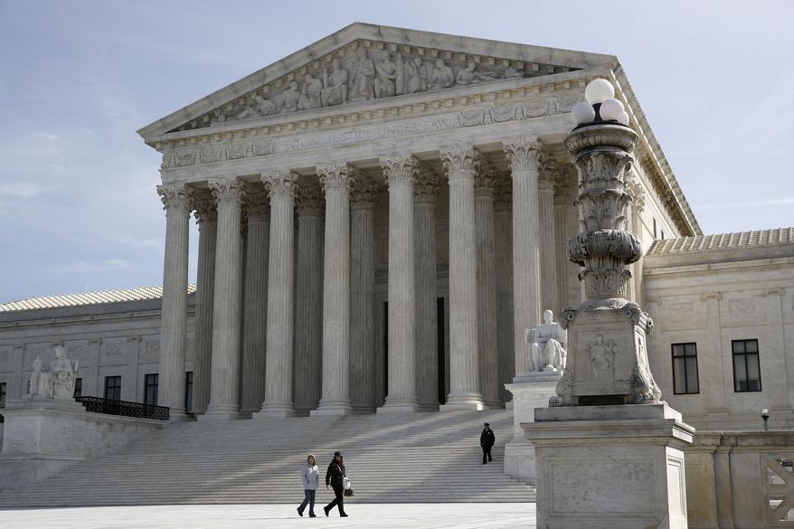 In this March 16, 2020 photo, people walk outside the Supreme Court in Washington. (AP Photo/Patrick Semansky)