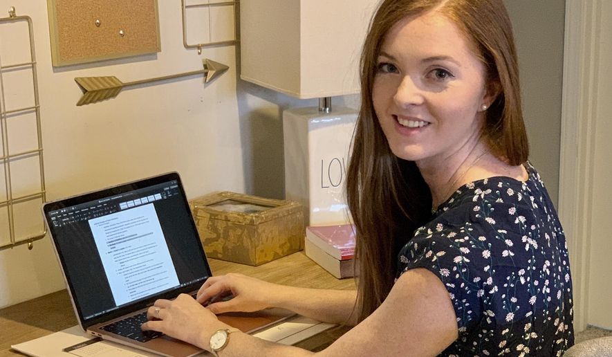 This photo provided by Jennifer C Hughes shows Emily Hughes as she poses for a photo in her home office in Xenia, Ohio on April 5, 2020. Hughes, in her final year of Law School at the University of Cincinnati, is studying to pass the bar exam. However, amid the COVID-19 pandemic, the organization that develops the exam — the National Conference of Bar Examiners — has raised the possibility that the July test may not be offered. But it doesn't plan to decide until May 5, leaving some 46,000 law students in limbo. (Jennifer C Hughes via AP)