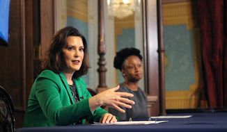 In a pool photo provided by the Michigan Office of the Governor, Michigan Gov. Gretchen Whitmer addresses the state during a speech in Lansing, Mich., Thursday, April 9, 2020. The governor signed an executive order extending her prior &amp;quot;Stay Home, Stay Safe&amp;quot; order through the end of April. The order limits gatherings and travel and requires all workers who are not necessary to sustain or protect life to stay home. The order also imposes more stringent limitations on stores to reduce foot traffic to slow the spread of the coronavirus. (Michigan Office of the Governor via AP, Pool)