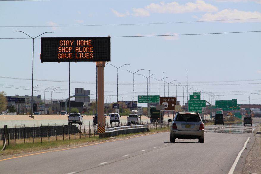 Flashing highway message boards along Interstate 25 in Albuquerque, New Mexico, urge people in both English and Spanish to stay home amid the coronavirus outbreak on Thursday, April 9, 2020. The new coronavirus causes mild or moderate symptoms for most people, but for some, especially older adults and people with existing health problems, it can cause more severe illness or death.(AP Photo/Susan Montoya Bryan)