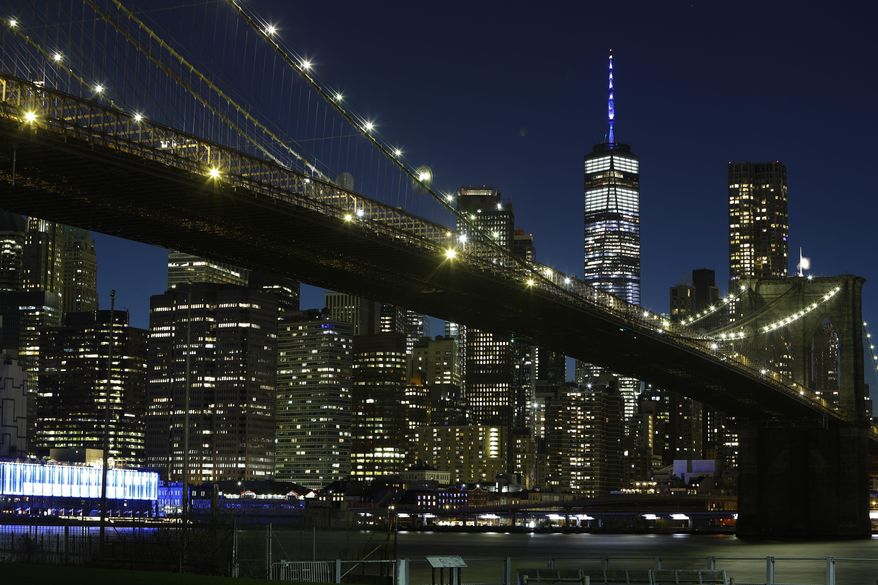 The mast of One World Trade Center is lit in blue to acknowledge essential workers on the front lines of the COVID-19 pandemic Thursday, April 9, 2020, in New York. (AP Photo/Frank Franklin II)