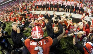 FILE - In this Oct. 4, 2014, file photo, Georgia running back Todd Gurley (3) celebrates with fans after defeating Vanderbilt 44-17 in an NCAA college football game in Athens, Ga. Gurley will be making a homecoming to the state of Georgia when  the former Georgia Bulldogs standout begins the second phase of his NFL career with the Atlanta Falcons. (AP Photo/John Bazemore, File)