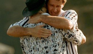 FILE - In this April 14, 1996, file photo, Nick Faldo hugs Greg Norman, left, as they finish up on the 18th hole of the Masters golf tournament at Augusta National Golf Club in Augusta, Ga. Faldo came from behind to beat Norman by five strokes to win his third Masters. (AP Photo/Dave Martin, File)