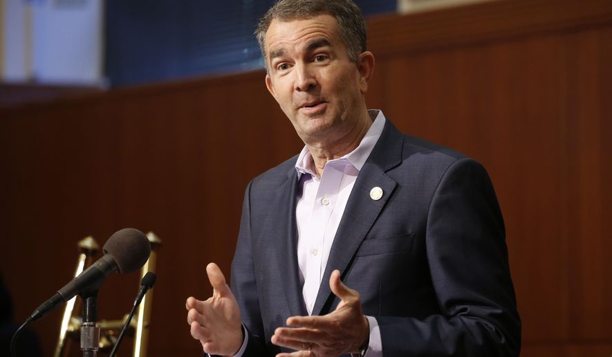 FILE - In this April 8, 2020 file photo, Virginia Gov. Ralph Northam gestures during a news conference at the Capitol in Richmond, Va. Gov.   Northam announced Friday, April 10  that he&#x27;d signed bills that include requiring universal background checks on gun purchases, a red flag bill to allow authorities to temporarily take guns away from people deemed to be dangerous to themselves or others, and legislation giving local governments more authority to ban guns in public places. (AP Photo/Steve Helber, File)
