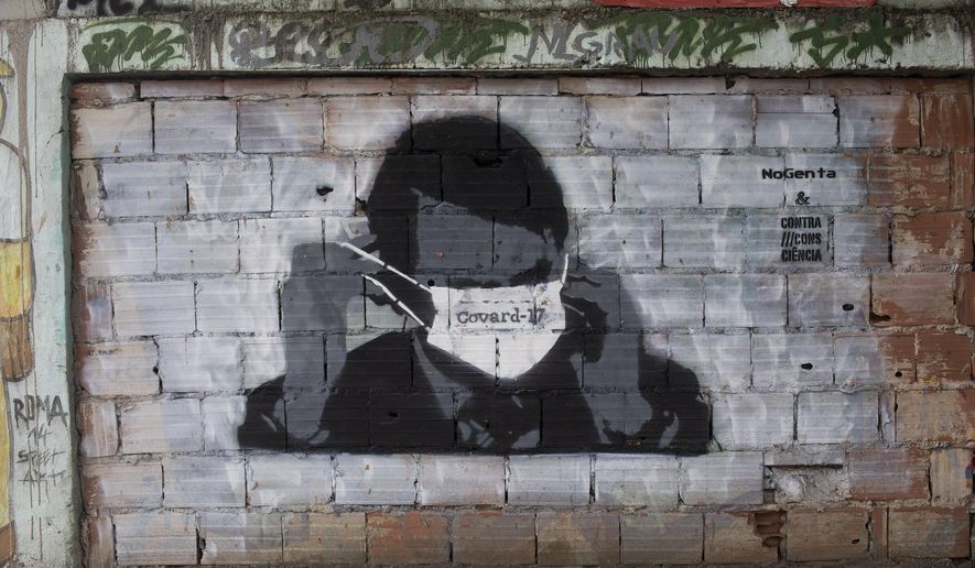 A graffiti of Brazil&#x27;s President Jair Bolsonaro wearing a protective mask in Rio de Janeiro, Brazil, Tuesday, April 7, 2020. Brazil is in the midst of a pitched battle over the effectiveness of isolation to avoid the spread of the new coronavirus, with Bolsonaro dismissing the virus’ severity and publicly taking aim at governors who impose shutdowns that he says could cripple the economy. (AP Photo/Silvia Izquierdo)