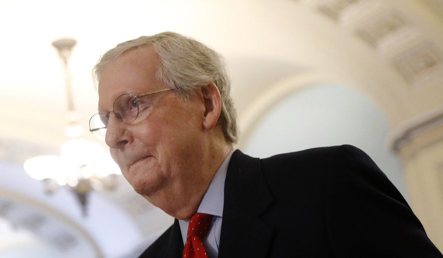 Senate Majority Leader Mitch McConnell of Kentucky walks to his office on Capitol Hill in Washington, Thursday, April 9, 2020. (AP Photo/Patrick Semansky) ** FILE **