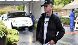 In this April 9, 2020 photo, actor and activist Sean Penn, founder of the nonprofit organization Community Organized Relief Effort (CORE), stands outside a CORE coronavirus testing site at Malibu City Hall in Malibu, Calif. The Oscar winner&#39;s disaster relief organization has teamed up with Los Angeles Mayor Eric Garcetti’s office and the city’s fire department to safely distribute free drive-through COVID-19 test sites for those with qualifying symptoms. (AP Photo/Chris Pizzello)