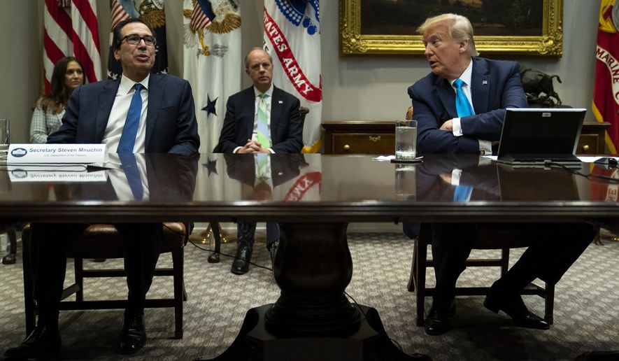 President Donald Trump listens as Treasury Secretary Steven Mnuchin speaks during a conference call with banks on efforts to help small businesses during the coronavirus pandemic, at the White House, Tuesday, April 7, 2020, in Washington. (AP Photo/Evan Vucci)
