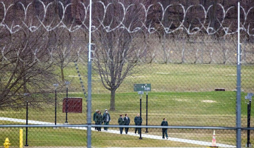 FILE - In this March 31, 2020, file photo, female inmates walk a path at the Taycheedah Correctional Institution in Fond du Lac, Wis. Two Wisconsin inmates with pre-existing conditions joined together with Disability Rights Wisconsin and criminal defense attorneys on Friday, April 10, 2020, to ask the state Supreme Court to release elderly and vulnerable inmates from the state prisons who would be at greatest risk if there is a coronavirus outbreak. (Mark Hoffman/Milwaukee Journal-Sentinel via AP)