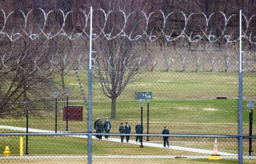 FILE - In this March 31, 2020, file photo, female inmates walk a path at the Taycheedah Correctional Institution in Fond du Lac, Wis. Two Wisconsin inmates with pre-existing conditions joined together with Disability Rights Wisconsin and criminal defense attorneys on Friday, April 10, 2020, to ask the state Supreme Court to release elderly and vulnerable inmates from the state prisons who would be at greatest risk if there is a coronavirus outbreak. (Mark Hoffman/Milwaukee Journal-Sentinel via AP)