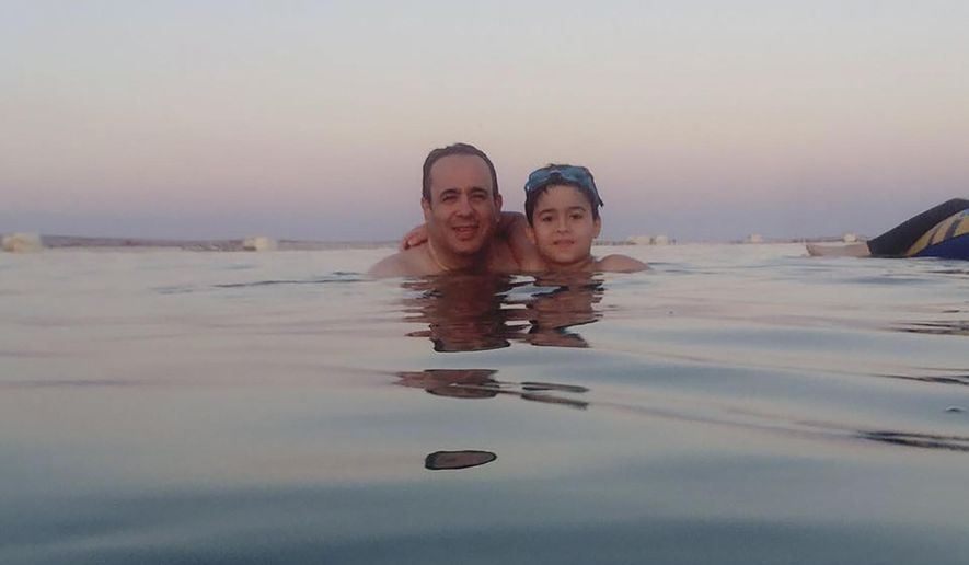 This 2016 photo provided by Israa el-Lawah shows Dr. Ahmed el-Lawah and his son during a vacation in Egypt. El-Lawah died on Monday, March 30, 2020, after he was infected by the new coronavirus. He was the first doctor to die from the COVID-19, the disease caused by the virus in Egypt. (Israa el-Lawah via AP)