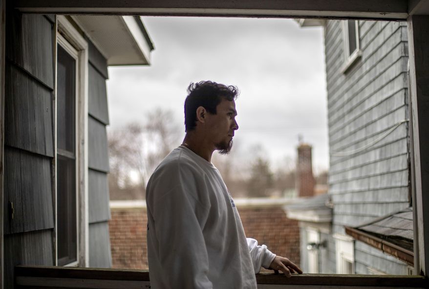 In this April 3, 2020, photo, house painter Jose Martinez stands on his front porch in Greenfield, Mass. Martinez said a pandemic stimulus check could have helped cover at least a month's worth of expenses, if he had qualified. The 34-year-old Mexican crossed the border illegally about 15 years ago and lives near the Vermont state line with his 4-year-old American-born daughter. (AP Photo/David Goldman)