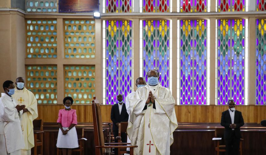 Priests conduct a service without a congregation, but which was broadcast on television, at the Cathedral Basilica of the Holy Family in Nairobi, Kenya, on Easter Sunday, April 12, 2020. The new coronavirus causes mild or moderate symptoms for most people, but for some, especially older adults and people with existing health problems, it can cause more severe illness or death. (AP Photo/Brian Inganga)