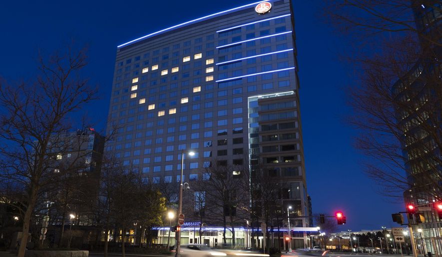 Windows in the Renaissance Boston Waterfront Hotel are illuminated in a heart shape during the coronavirus outbreak, Saturday, April 11, 2020, in Boston. (AP Photo/Michael Dwyer)