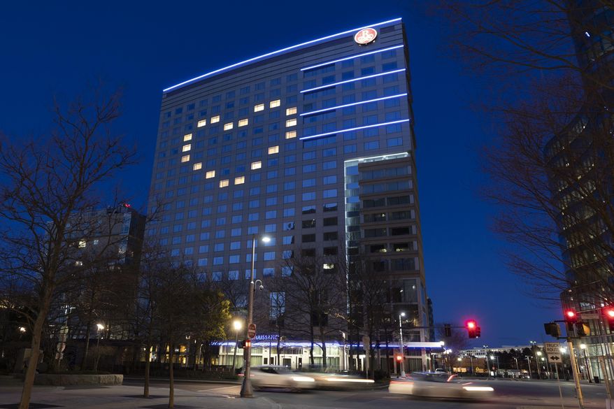Windows in the Renaissance Boston Waterfront Hotel are illuminated in a heart shape during the coronavirus outbreak, Saturday, April 11, 2020, in Boston. (AP Photo/Michael Dwyer)